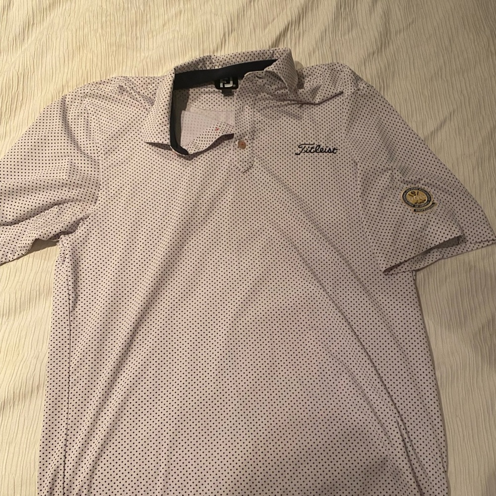 White and black titelist golf shirt with PGA logo
